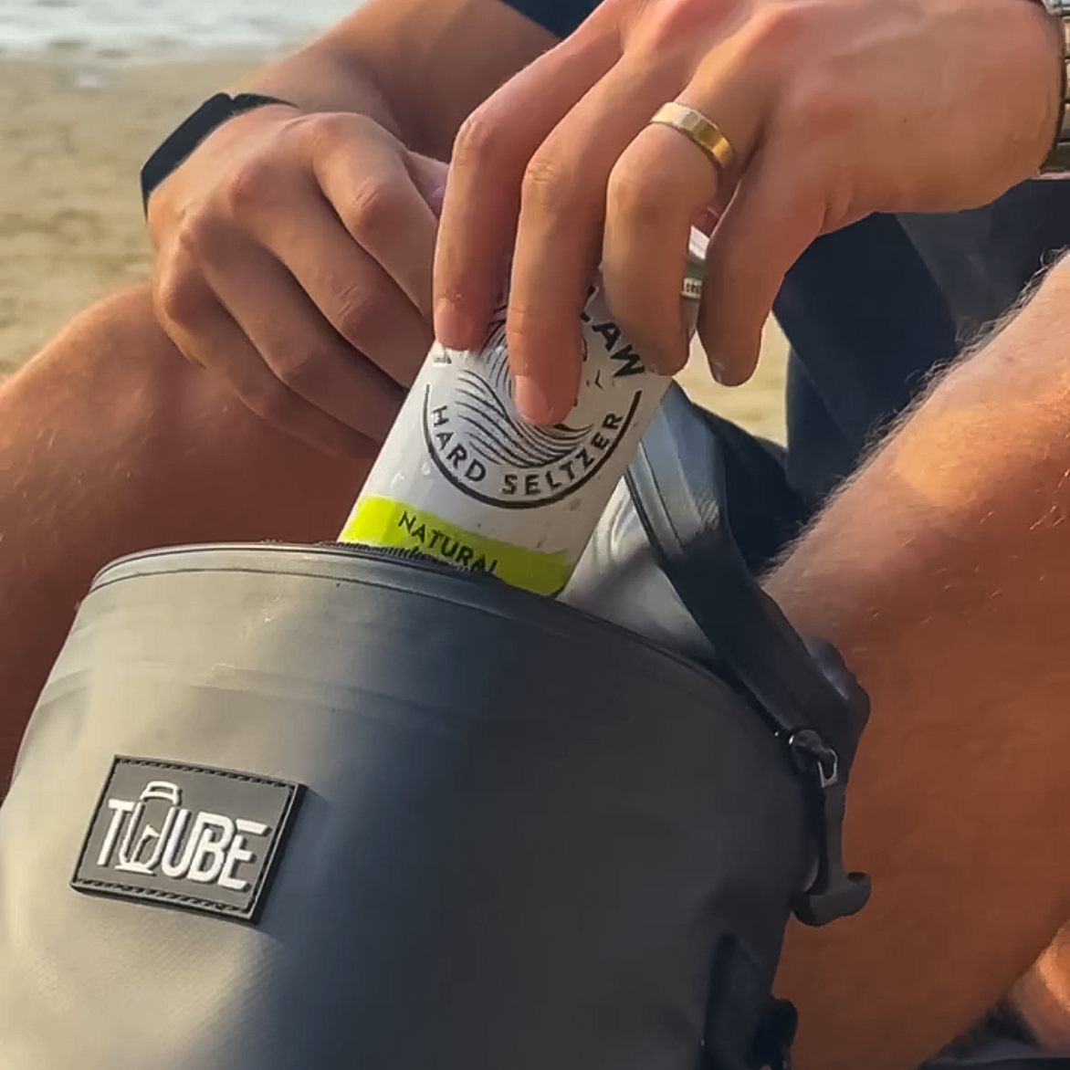 Top-down flat lay of open Tuube Weekender 8L black cooler bag, 8L insulated interior with heat-welded seams and leakproof inner coating
136 chars