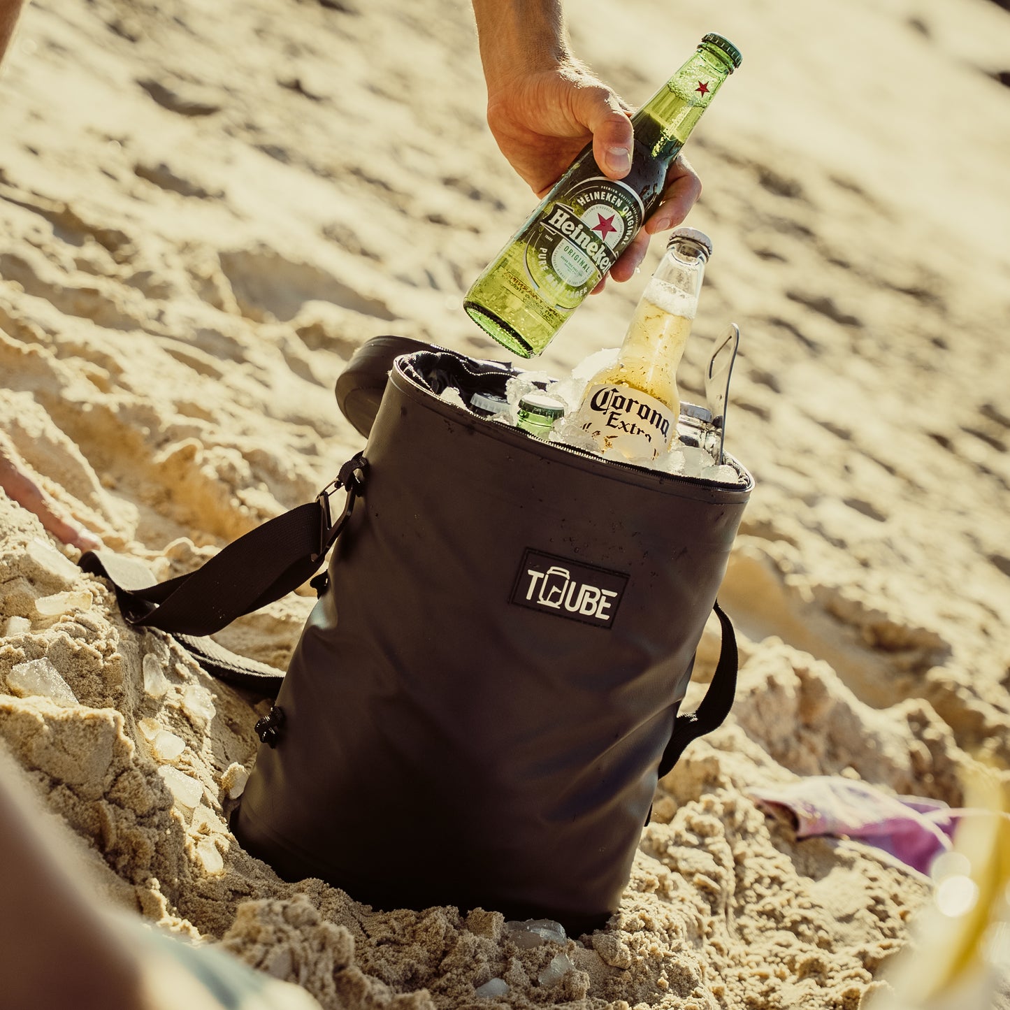 Black Tuube Weekender 8L cooler bag in use on a golf course, 8L capacity with 8mm NBR insulation keeping 12 drinks cold all round