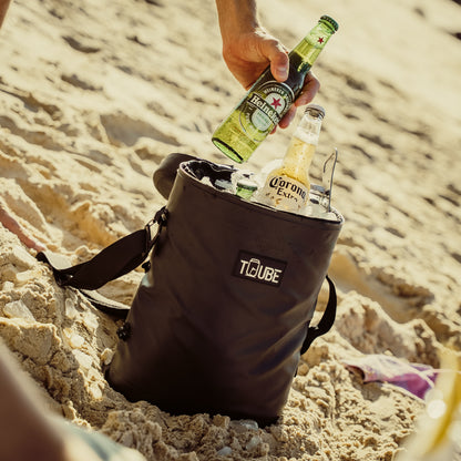 Black Tuube Weekender 8L cooler bag in use on a golf course, 8L capacity with 8mm NBR insulation keeping 12 drinks cold all round