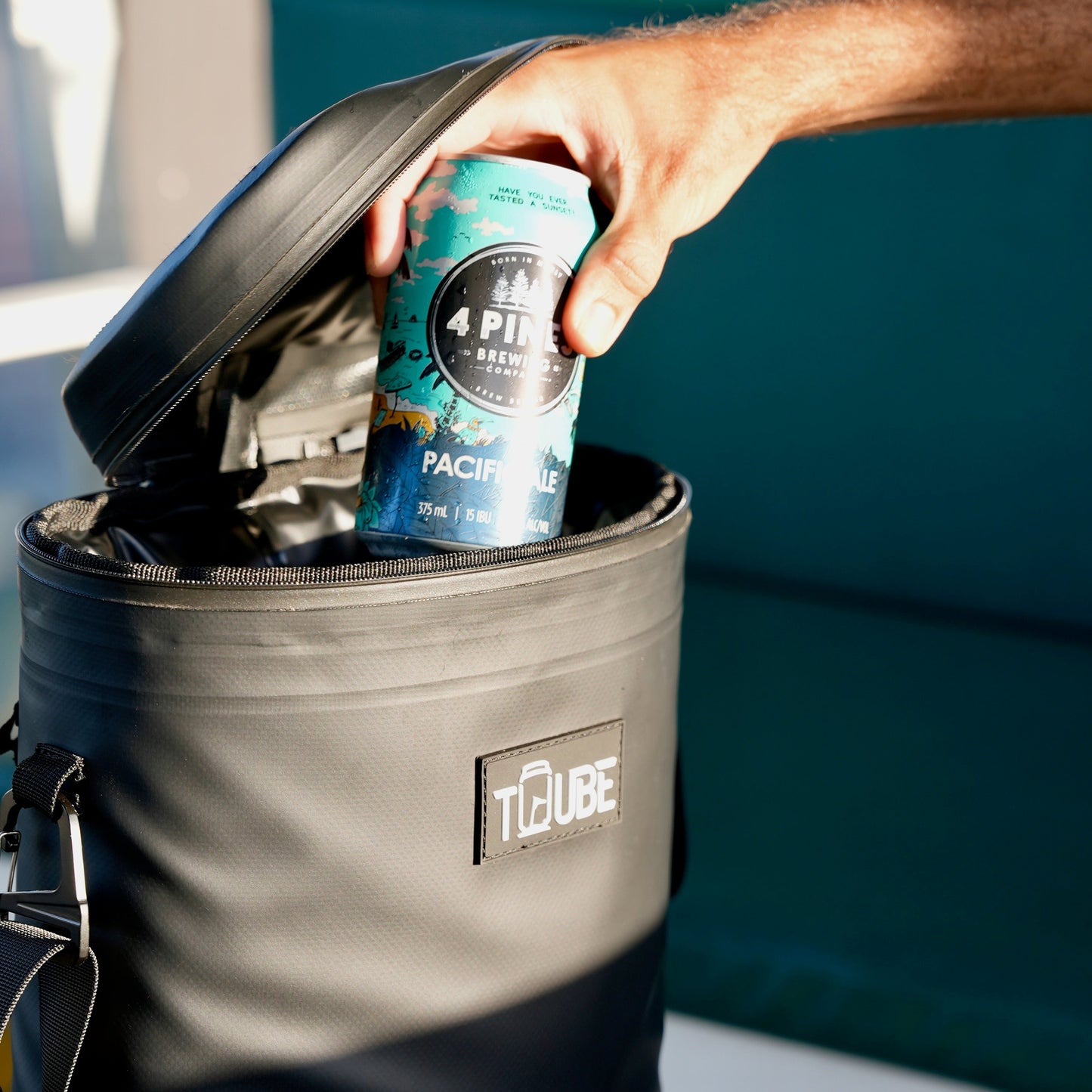Black Tuube Weekender 8L cooler bag attachment loop detail, single clip point designed to secure directly to a golf bag or cart strap
