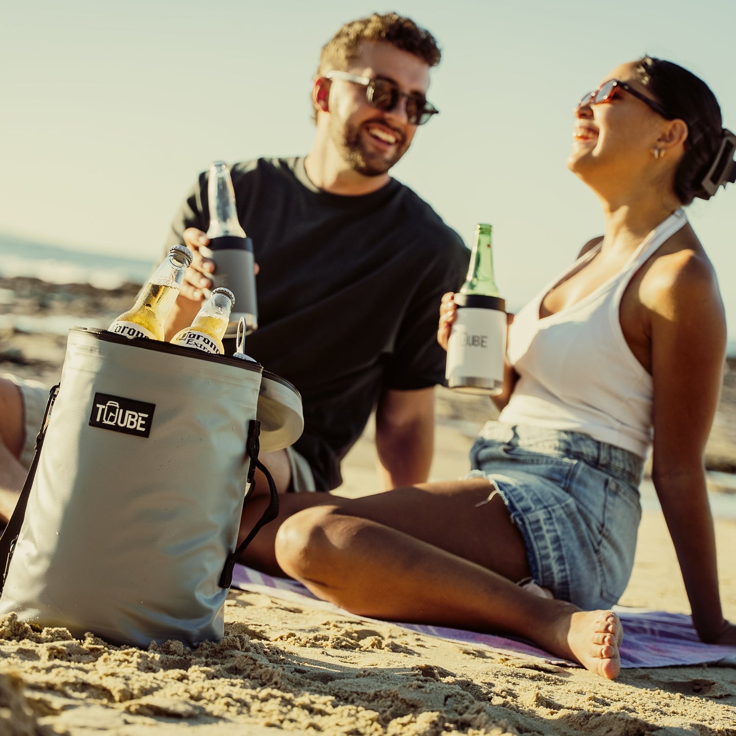 Grey Tuube Weekender 8L cooler bag carried by handle, 8mm NBR insulation visible through side profile, built for golf and weekend use