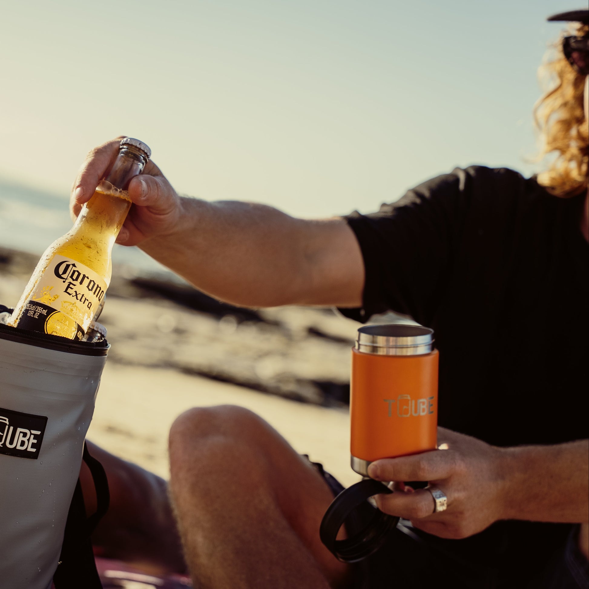 Orange Tuube stainless steel cooler outdoors, bold colourway matching orange Tuube Cooler Bag 2.0 golf accessories