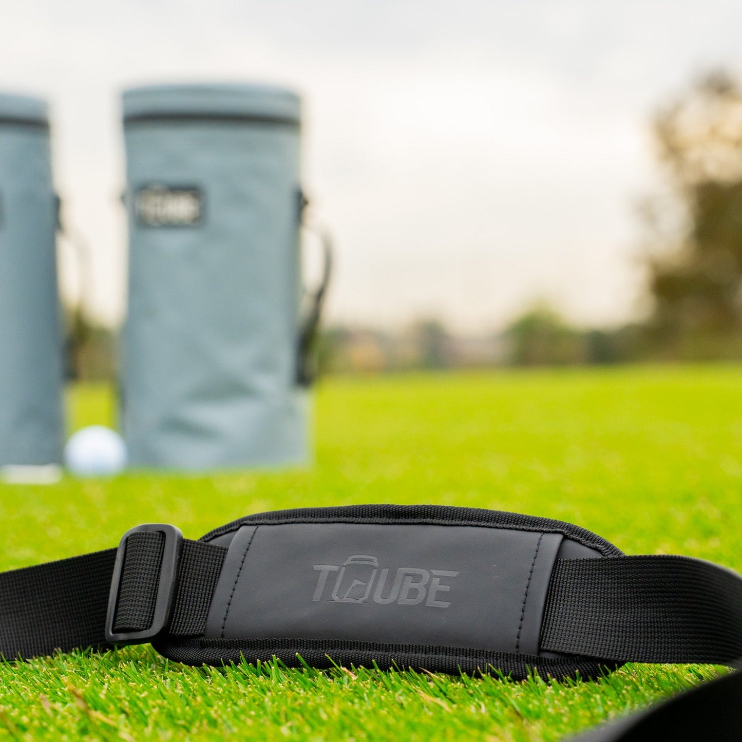 Tuube Embossed Shoulder Strap - Black - Front view in the grass. 