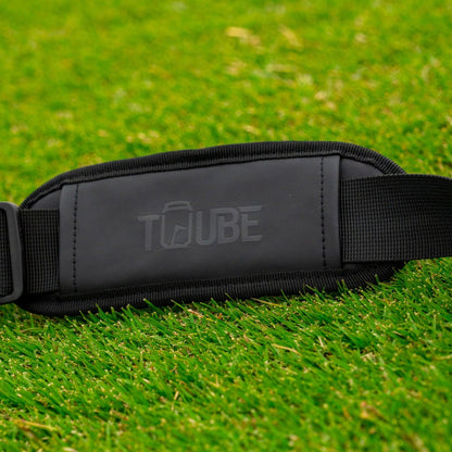 Tuube embossed shoulder strap - strap laying on grass. 