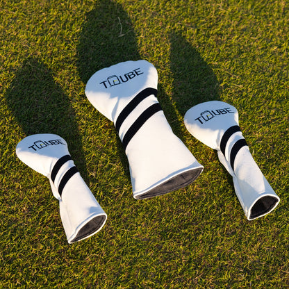 Tuube head cover set on clubs lying on a golf course green, premium material and Tuube branded design in natural setting