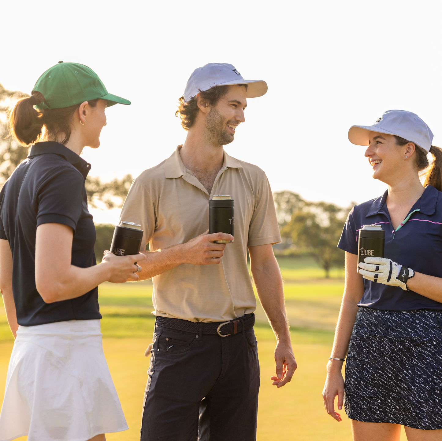 Three Tuube 5-panel hats in white, green and blue displayed together, showing adjustable velcro golf hat colour range