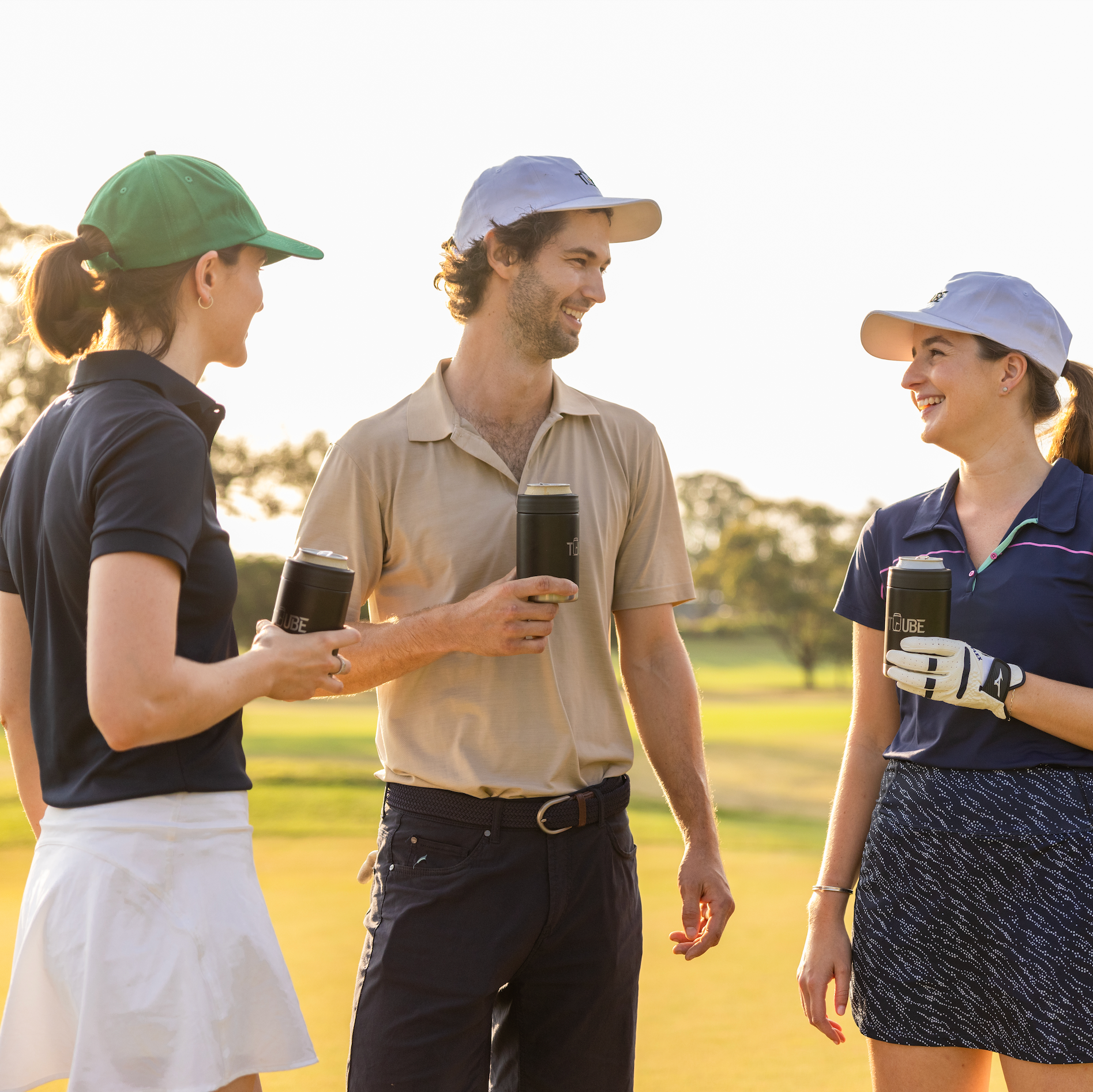 Three Tuube 5-panel hats in white, green and blue displayed together, showing adjustable velcro golf hat colour range