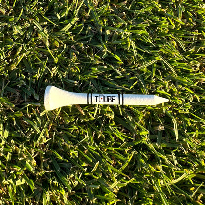 Tuube short 54mm tee inserted in turf, demonstrating lower tee height for irons with durable plastic construction