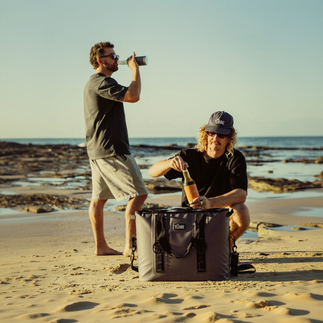 Tuube Traveller 36L cooler bag at golden hour during lifestyle shoot, showing adjustable shoulder strap for beach and travel carry