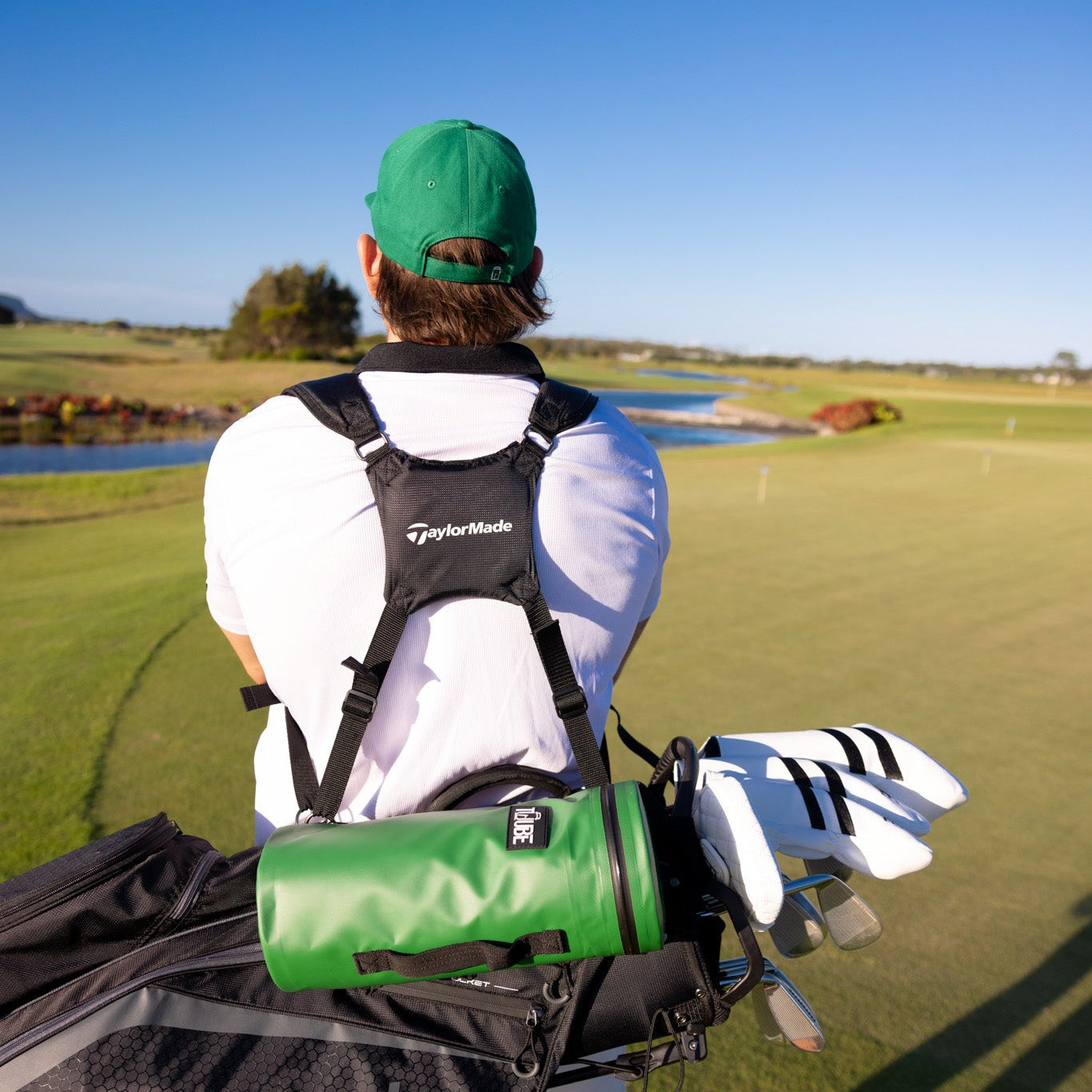 Green Tuube 2.0 cooler bag lifestyle shot clipped to a carry bag during a round, demonstrating on-course functionality