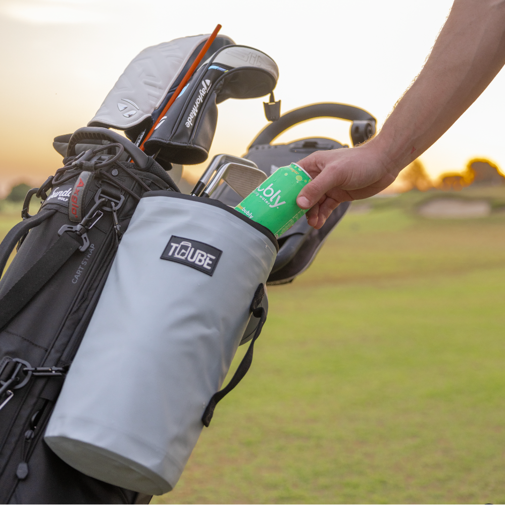Grey Tuube 2.0 cooler bag open with chilled cans visible inside, showing 6-can capacity and PVC tarpaulin exterior