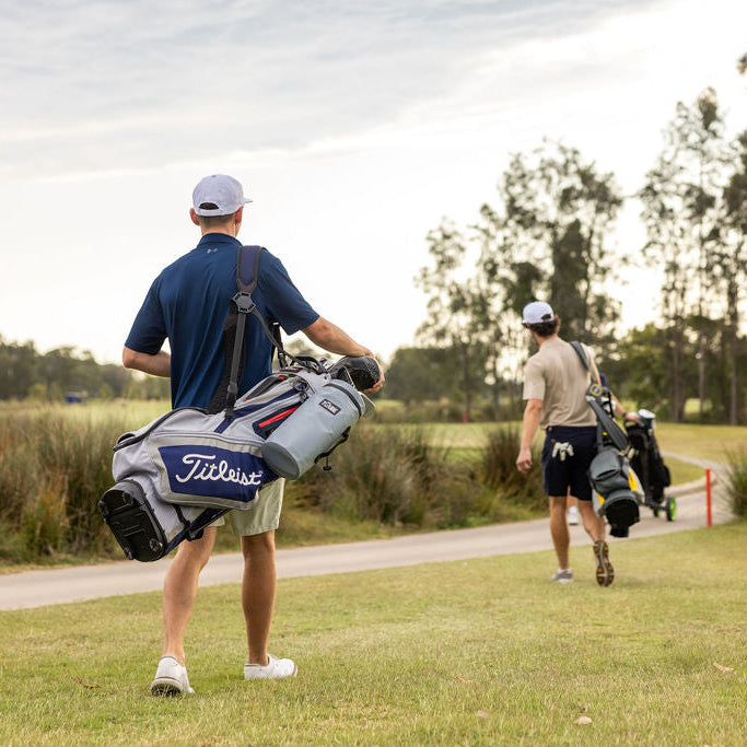 Golfer with grey Tuube Cooler Bag 2.0 clipped to their stand bag on the fairway, leakproof attachable cooler in action