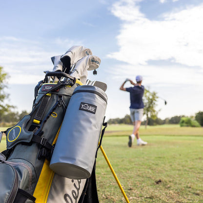 Action shot of grey Tuube Cooler Bag 2.0 secured to a golf bag on course, showing 8 looping points and nylon carry handle