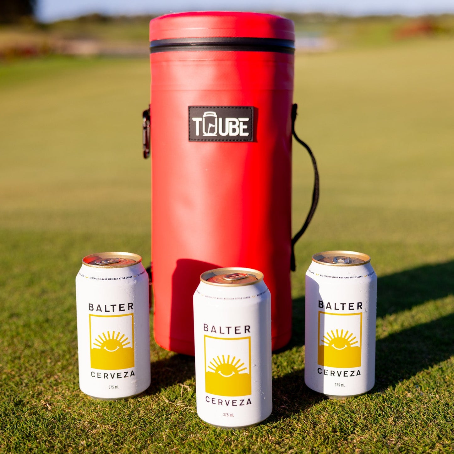 Close-up of red Tuube 2.0 cooler bag showing 8 looping points and leakproof zipper, attachable insulated golf cooler