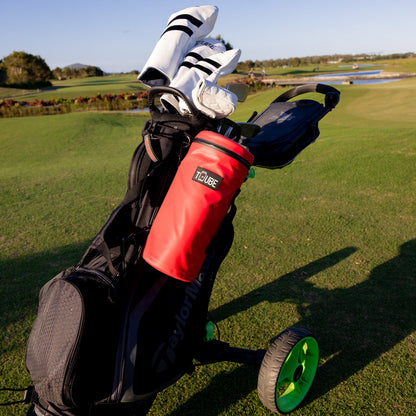 Red Tuube 2.0 cooler bag clipped to golf cart bag, demonstrating versatile looping attachment system on course