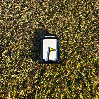 Tuube Can Ball Marker placed on a golf green during a round, showing scale and visibility of the can-design metal marker