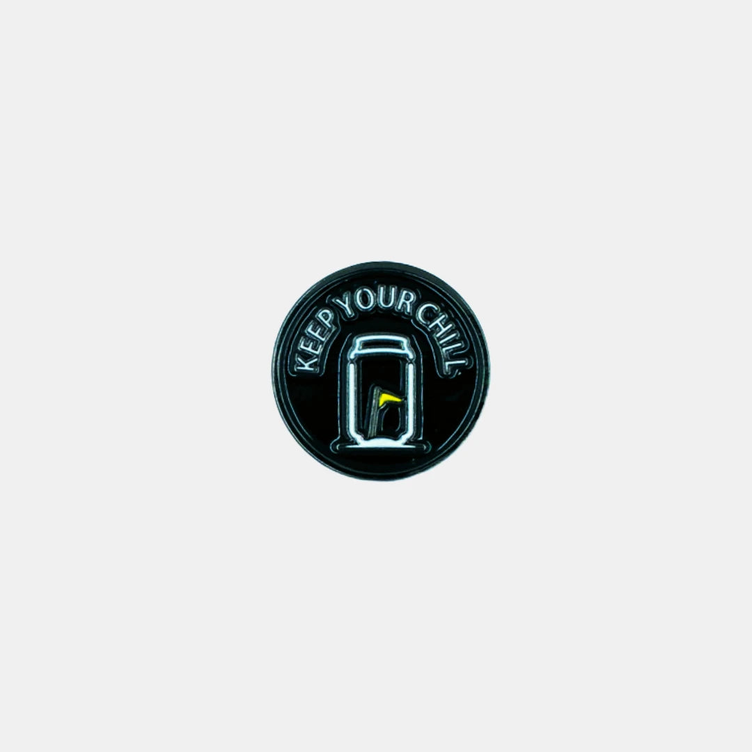 Tuube Keep Your Chill ball marker in black and grey, flat metal coated design with Tuube branding, durable golf accessory for the green