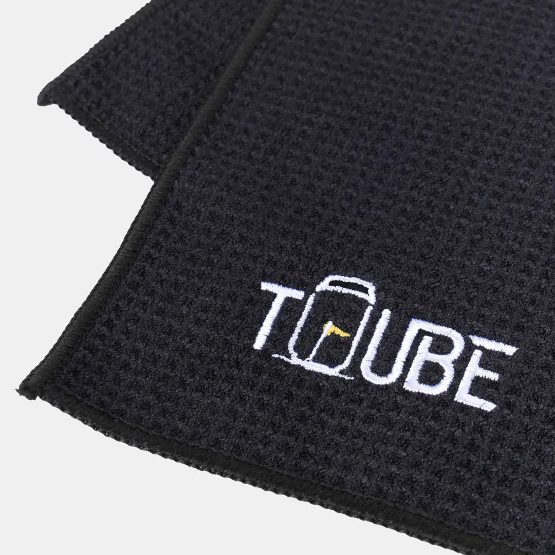 Black Tuube microfiber golf towel with carabiner clip, attaches to any golf bag for quick club and hand cleaning on the course