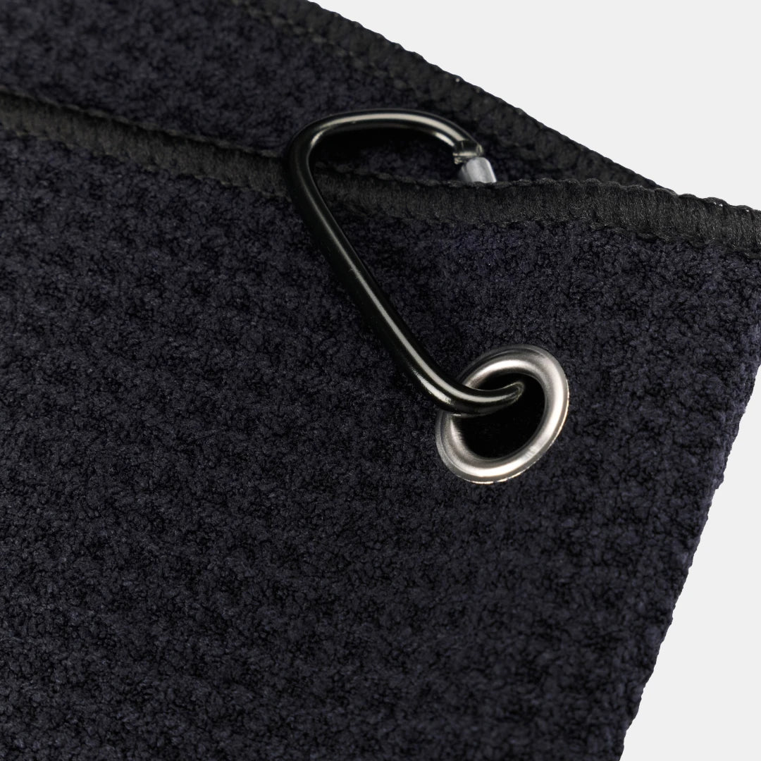 Black Tuube microfiber clip towel showing soft microfiber texture and integrated carabiner, folds compactly for golf bag attachment