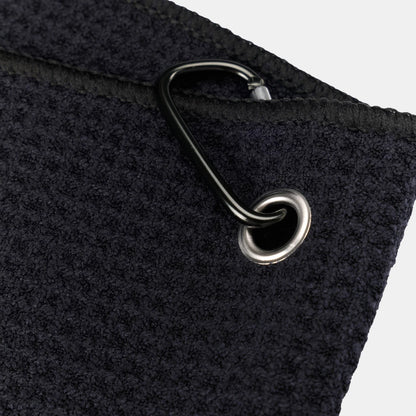 Black Tuube microfiber clip towel showing soft microfiber texture and integrated carabiner, folds compactly for golf bag attachment