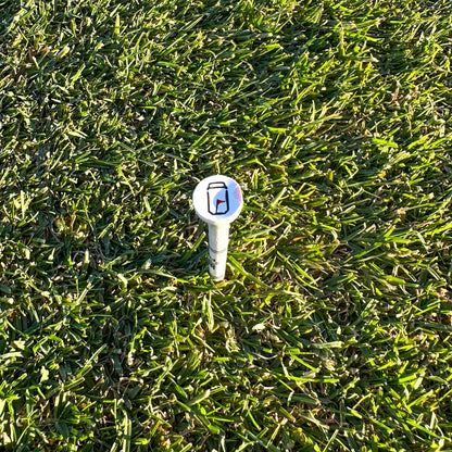 Tuube 54mm short golf tees arranged on a course, showing compact profile suitable for iron and fairway wood tee height